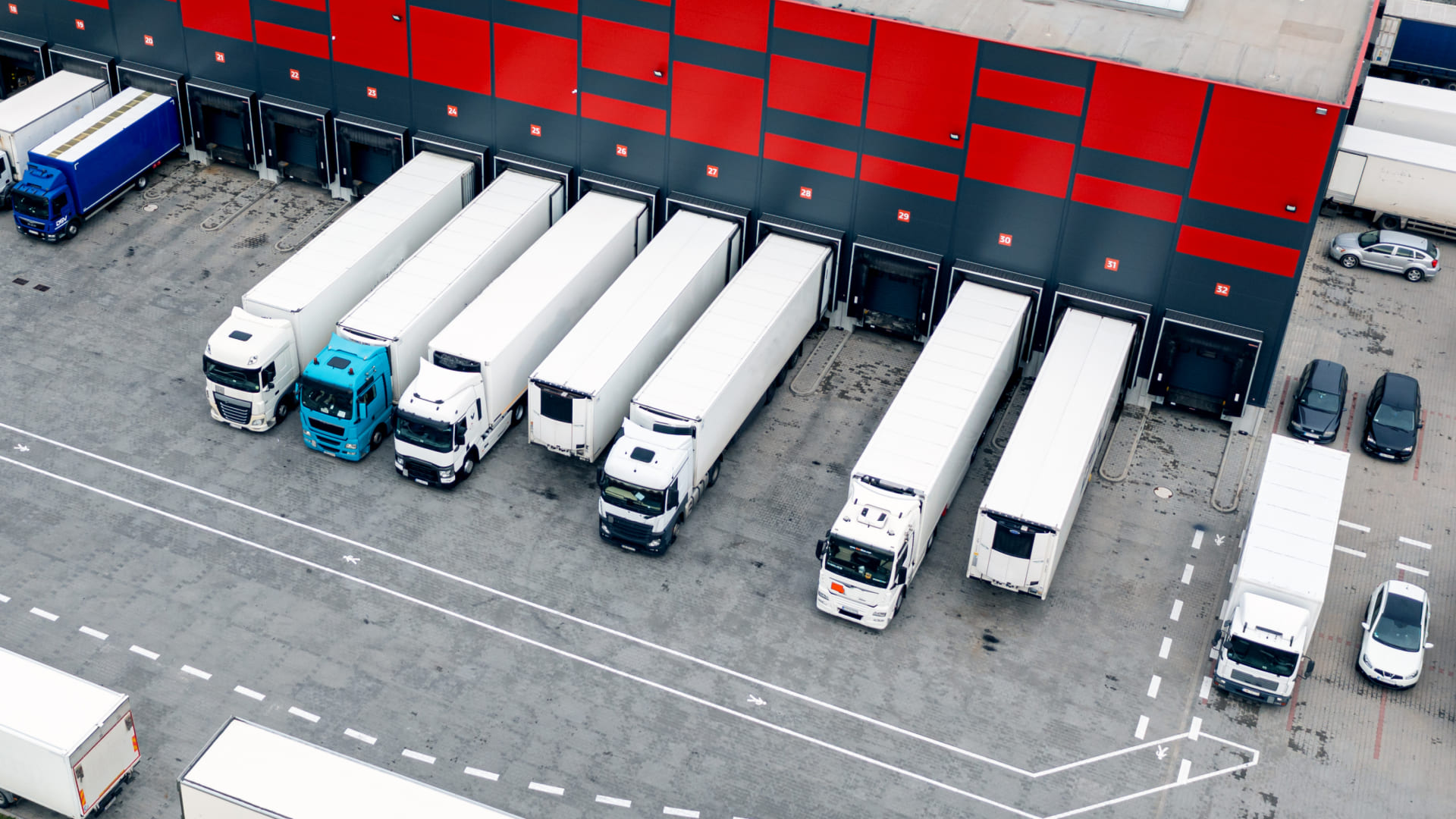 Multiple 18-wheelers in a busy loading bay